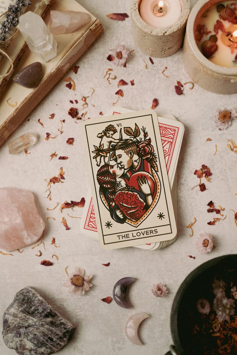 A flat lay of tarot cards and crystals promoting mindfulness and spiritual healing.