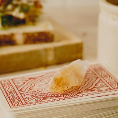 A mystical crystal placed on ornate tarot cards, suggesting a scene of fortune telling.